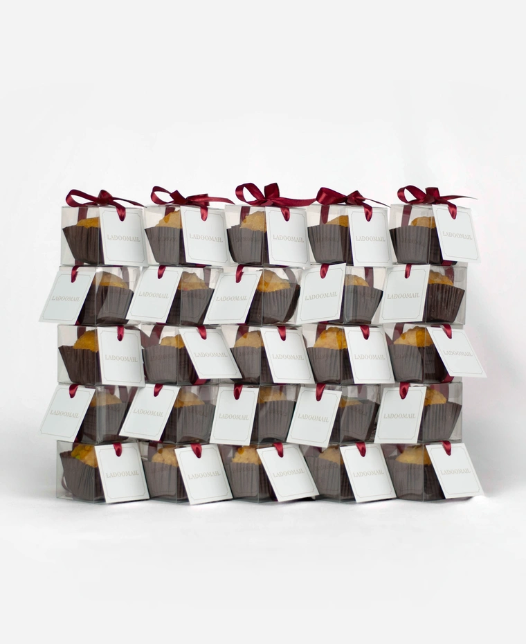 Pack of 25 Ladoomail celebration favours, each tied with a signature burgundy ribbon and swing tag.