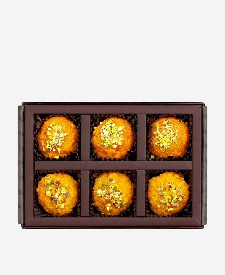 Pistachio Ladoo Selection gift box, 6 pieces, open: boondi and motichoor ladoo topped with chopped pistachio in a burgundy box with gold foil lettering.