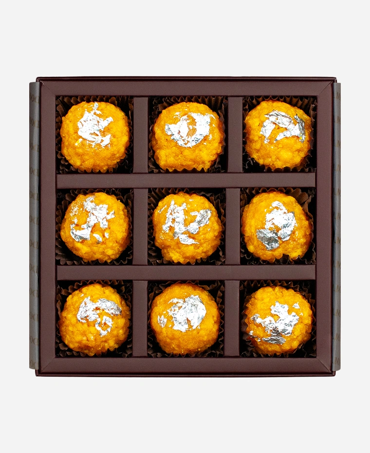 Silver Leaf Boondi Ladoo gift box, 9 pieces, open: golden boondi ladoo topped with edible silver leaf in a burgundy box with gold foil lettering.
