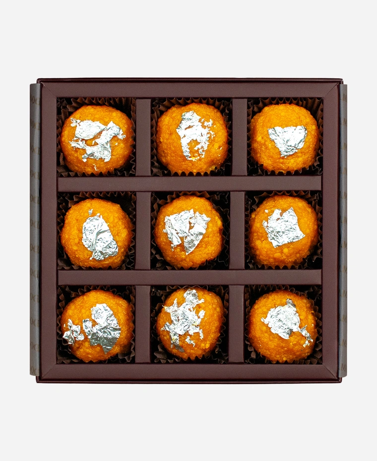 Silver Leaf Motichoor Ladoo gift box, 9 pieces, open: fine-grained motichoor ladoo topped with edible silver leaf in a burgundy box with gold foil lettering.