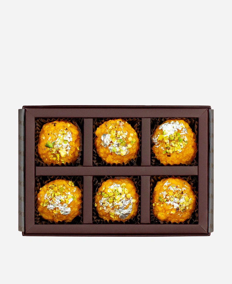 Silver Leaf & Pistachio Boondi Ladoo gift box, 6 pieces, open: golden boondi ladoo topped with edible silver leaf and chopped pistachio in a burgundy box with gold foil lettering.
