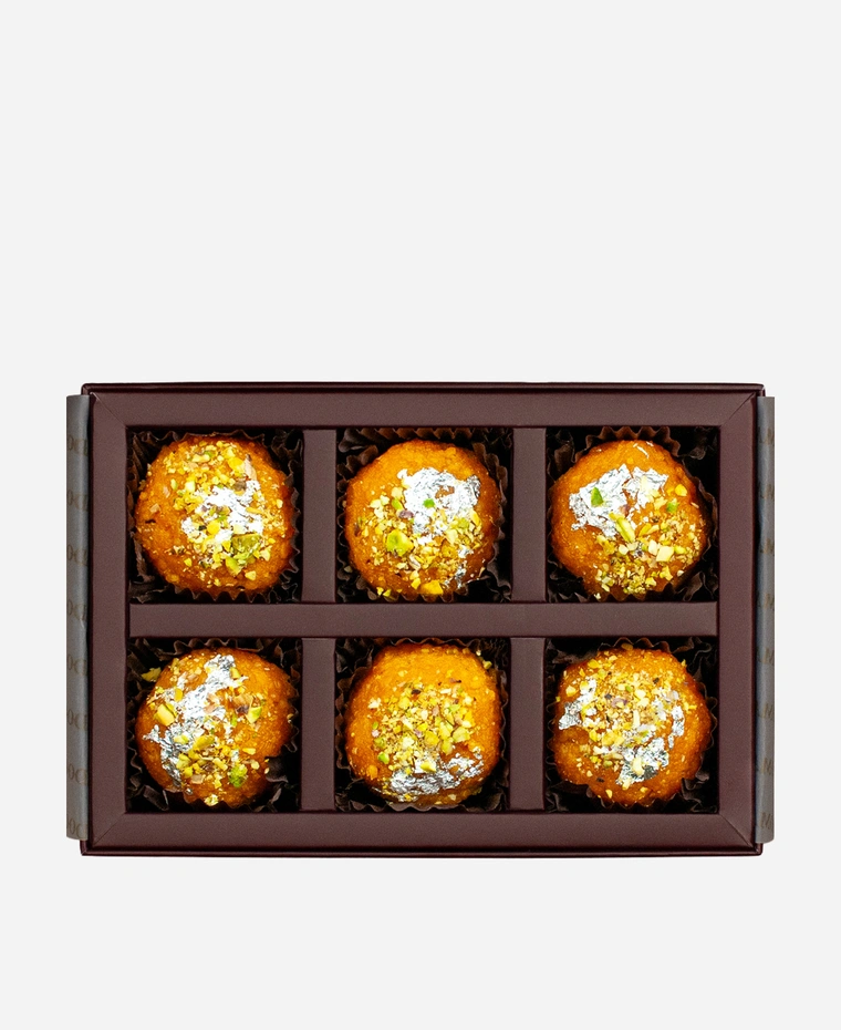 Silver Leaf & Pistachio Motichoor Ladoo gift box, 6 pieces, open: fine-grained motichoor ladoo topped with edible silver leaf and chopped pistachio in a burgundy box with gold foil lettering.