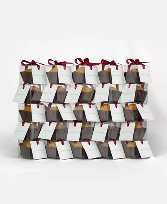 Pack of 25 Ladoomail celebration favours, each tied with a signature burgundy ribbon and swing tag.