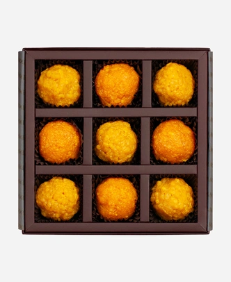 Classic Ladoo Selection gift box, 9 pieces, open: boondi and motichoor ladoo in a burgundy box with gold foil lettering.