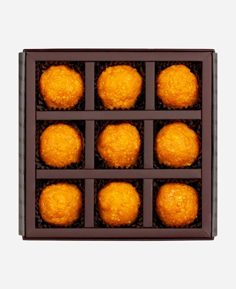 Classic Motichoor Ladoo gift box, 9 pieces, open: fine-grained motichoor ladoo in a burgundy box with gold foil lettering.