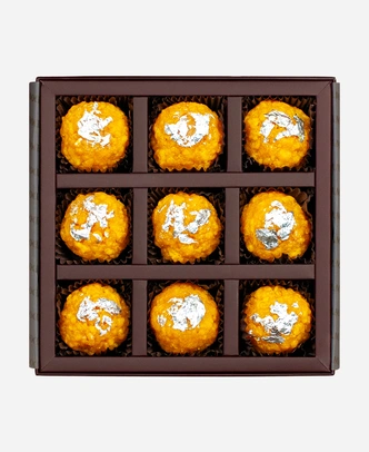 Silver Leaf Boondi Ladoo gift box, 9 pieces, open: golden boondi ladoo topped with edible silver leaf in a burgundy box with gold foil lettering.