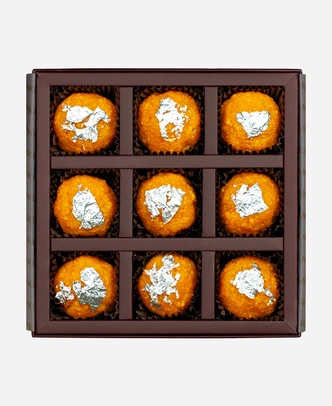 Silver Leaf Motichoor Ladoo gift box, 9 pieces, open: fine-grained motichoor ladoo topped with edible silver leaf in a burgundy box with gold foil lettering.