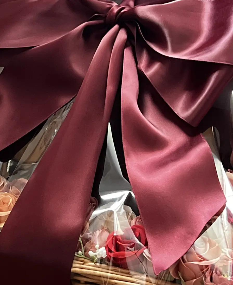 Gift baskets Large burgundy silk bow on a Ladoomail gift basket with rose florals.