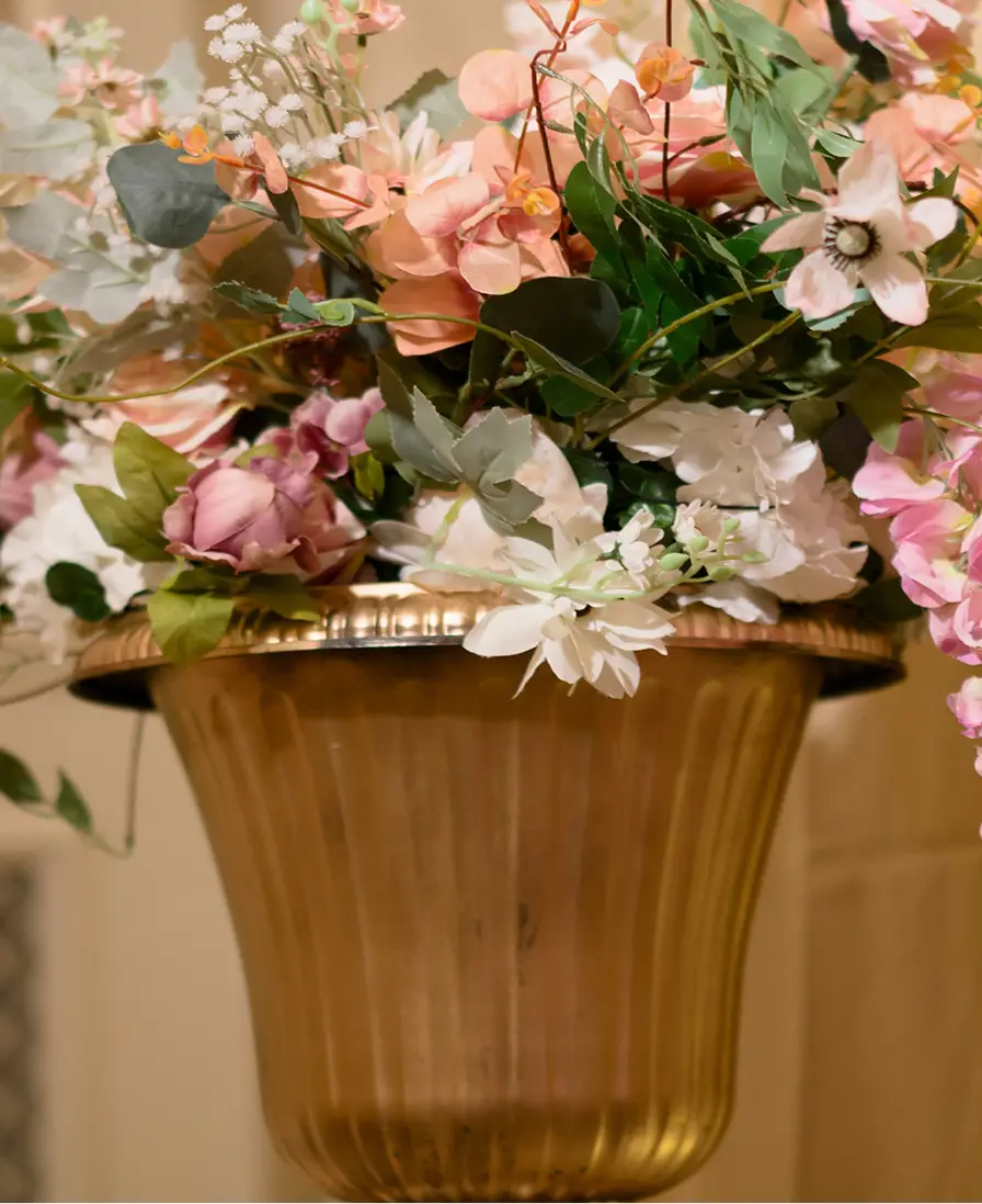 Gold urn of pink, peach and white florals, a bespoke Ladoomail mithai display centrepiece.