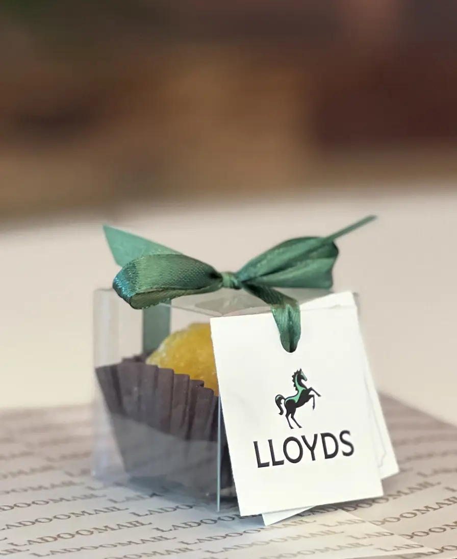 Ladoomail celebration favour with green ribbon and a Lloyds Bank swing tag.