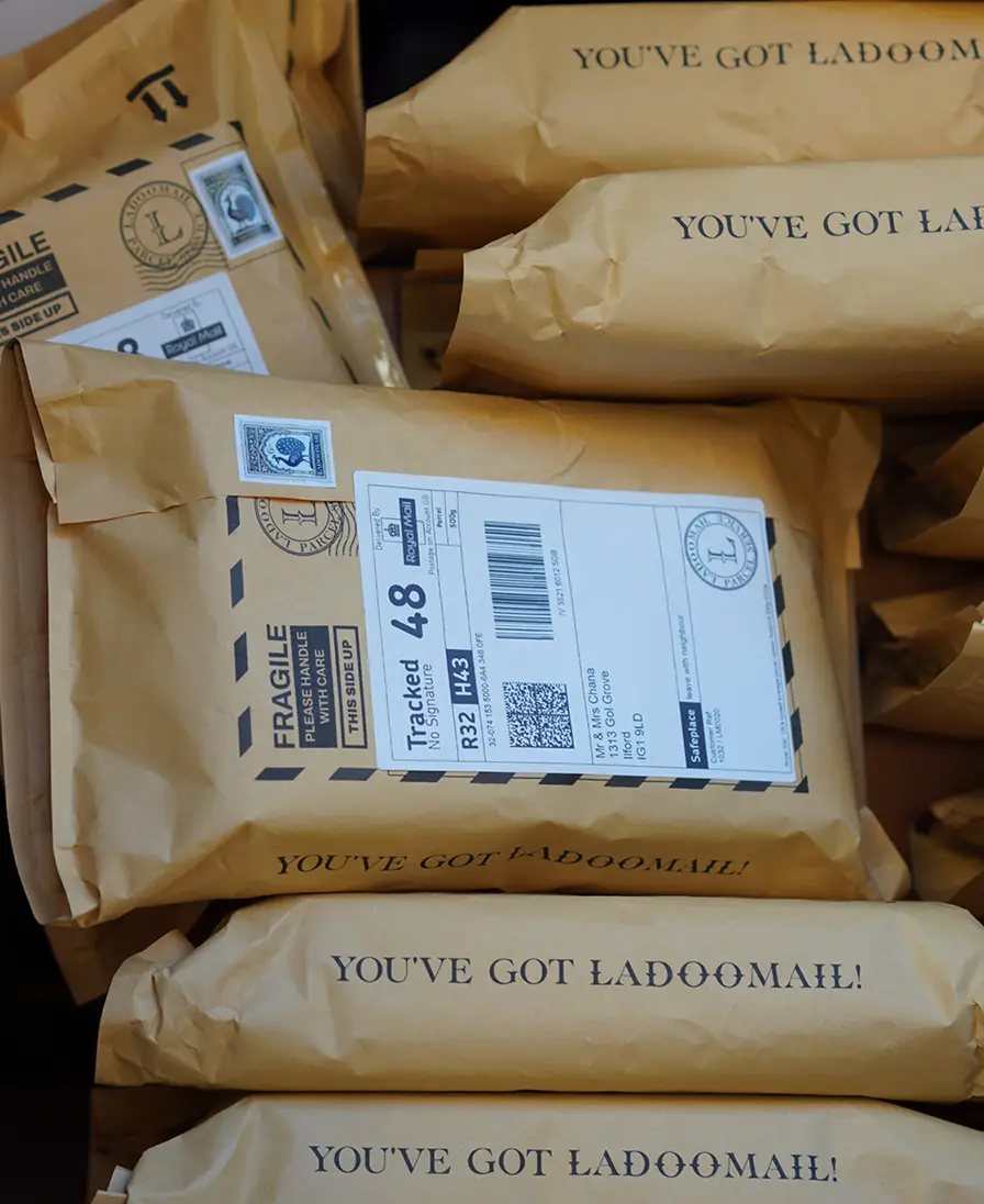 Ladoomail brown airmail parcels printed 'You've Got Ladoomail!' with delivery labels.